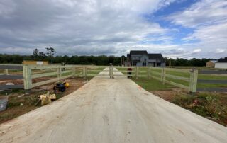 3-rail wood fence installation by Colony Fence Company with new construction home in Baldwin County, AL